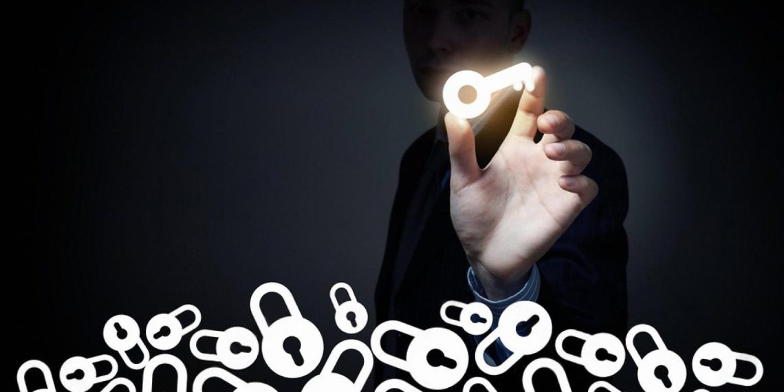 Man holding a glowing key above locked padlocks, symbolising hidden ultimate beneficial ownership